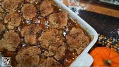 a casserole dish with meatballs and gravy in it on a table