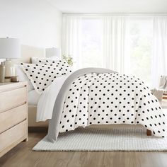 a bed with black and white polka dots on it