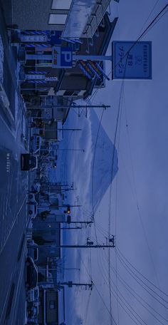 the street is lined with cars and telephone poles