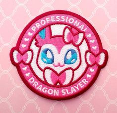 a pink patch with the words professional dragon slayer on it's side and an image of a cat