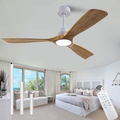 a bedroom with a large bed and ceiling fan in the middle of it's room