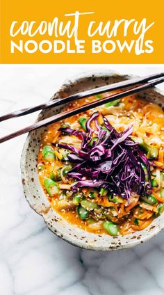 a bowl filled with noodles and vegetables next to chopsticks on a marble surface