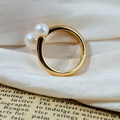 🌻This minimalist ring combines natural pearls with gold-plated silver, enhanced by a unique design. 🥰This piece is meticulously crafted from S925 sterling silver and pearl (total 4.0g) and finished with a luxurious coating of genuine 18k gold plating. 🥰This ring is adjustable to fit your desired size. 🥰We will send it in a beautiful jewelry box and package it carefully. We offer boxes in blue, green, white, and black. Please leave a message specifying your preferred color 🥰Please leave a me Everyday Gold Pearl Open Ring, Gold Pearl Charm Open Ring, Gold Everyday Pearl Ring With Pearl Drop, Minimalist Pearl Drop Ring For Gift, Modern Gold Pearl Ring For Everyday, Everyday Gold Pearl Ring With Pearl Drop, Everyday Gold Pearl Drop Ring, Everyday Gold Ring With Pearl Charm, Modern Everyday Gold Pearl Ring