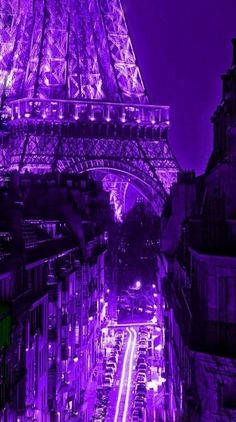 the eiffel tower is lit up in purple