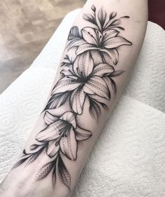 a black and white flower tattoo on the arm