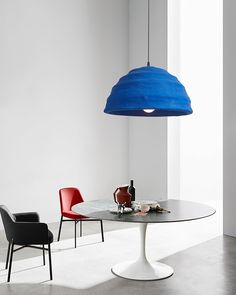 a table with two chairs and a blue light hanging from it's center point