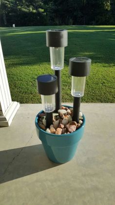 a blue bowl filled with rocks and two small lights on top of it's sides