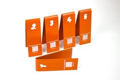 four orange numbered signs on white background with qr code for each item in the center