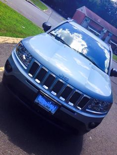 a blue jeep is parked on the street