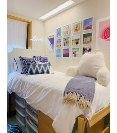 a white bed with lots of pillows on it