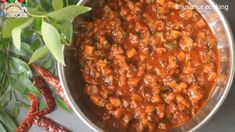 a pot filled with lots of food on top of a table next to some vegetables