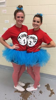 two girls dressed up as dr seuss and the cat in the hat with their hands on their hips