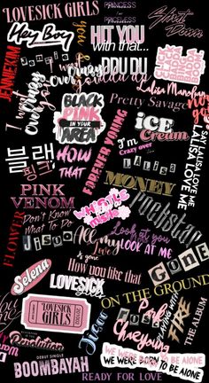 many different types of stickers on a black surface with pink and white writing in the middle