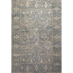 an area rug with blue and grey colors on the ground, including a large floral design