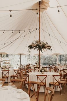 a large tent with tables and chairs set up for an event