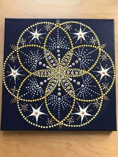 a painting with stars on it sitting on top of a wooden table