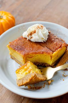 a slice of pumpkin pie on a plate with a scoop of ice cream in the middle