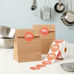 two brown paper bags sitting on top of a table