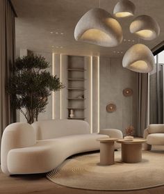 a living room filled with white furniture and lots of lights hanging from the ceiling above