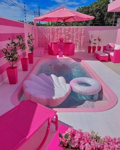 an outdoor hot tub with pink furniture and umbrellas