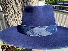 Designer choice!! Take a look at this fun denim blue adjustable hatband with different colors of denim that really make this hatband pop on any style/color of hat. The band is 22.5" x 1.25" and has adjustable navy-blue suede ties in the back so it can fit hats from 22.5-34". The band is secured by two gold tie clamps in the back to give it a nice, finished look. The hat band has been sewn together and treated with fray protector to help keep this hatband looking good for years to come. To comple Blue Felt Hat With Flat Brim For Festivals, Blue Flat Brim Felt Hat For Festival, Blue Brimmed Felt Hat For Festival, Adjustable Denim Blue Wide Brim Hat, Denim Blue Brimmed Hat, One Size Fits Most, Adjustable Wide Brim Denim Blue Hat, Denim Blue Wide Brim Hat With Adjustable Fit, Adjustable Navy Wide Brim Hat, One Size Fits Most Brimmed Denim Blue Hat