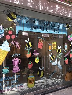 a store front window with various stickers on it's glass and the words, without bees we wouldn't have all of these