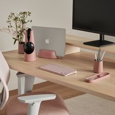 an apple computer sitting on top of a wooden desk