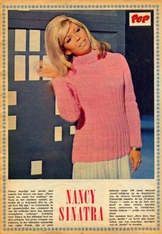 a woman in pink sweater and white skirt posing for a magazine cover with her hand on her shoulder