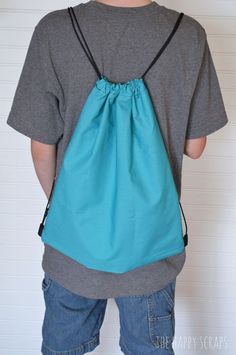 a young boy wearing a drawsack bag with the words 30 minute draw string bag