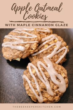 three apple oatmeal cookies with maple cinnamon glaze on a black plate