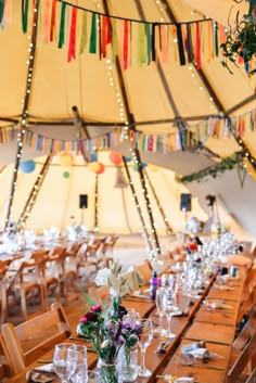 a large tent with tables and chairs set up for an event or gathering in it