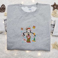 Introducing our Goofy Christmas Elements Embroidered Shirt, a festive must-have for Disney fans! This shirt features high-quality embroidery of beloved Disney characters like Mickey, Minnie, Donald, and Goofy, adding a touch of magic to your holiday wardrobe. Made with soft and breathable fabric, it offers superior comfort while keeping you warm during the chilly Christmas season. With its vibrant colors and intricate designs, this shirt is sure to make you stand out at any holiday gathering. Sp Christmas Gifts For Family, Best Family Gifts, Minnie Mouse Christmas, Minnie Christmas, Embroidered Shirts, Christmas Elements, Mouse Christmas, Mickey Christmas, Mickey Mouse Christmas