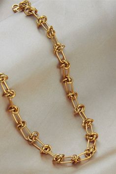 This necklace is chunky with knot details. It’s gold with an adjustable link. Length: 9” Luxury Gold Plated Cable Chain Necklace, Luxury Adjustable Hand Knotted Necklaces, Gold Chunky Chain Link Necklace, Chunky Gold Oval Link Necklace, Chunky Link Gold Necklace, Gold Chunky Oval Link Necklace, Gold Chunky Link Necklace, Knotted Necklace, Gold Link Chain