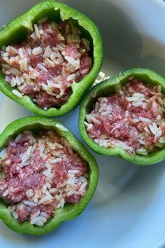 three green peppers filled with rice and meat