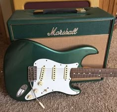 an electric guitar and amp sitting on the floor