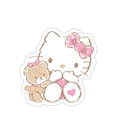 a hello kitty sticker sitting next to a teddy bear