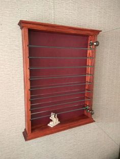 a wooden shelf with metal bars on the top and bottom, mounted against a wall