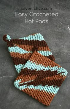 two brown and blue crocheted dishcloths sitting on top of a table