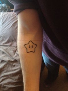 a person with a star tattoo on their arm