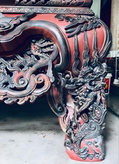 an ornately carved bench in the shape of a dragon