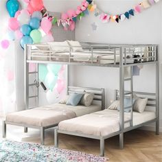 two bunk beds in a room with balloons on the wall