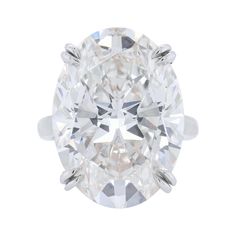 an oval cut diamond ring on a white background