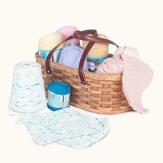 a basket filled with lots of different types of knitting supplies next to a pair of socks