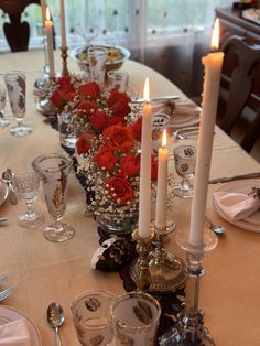 the table is set with candles and flowers