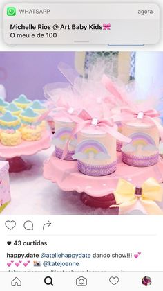 there are many little cakes on the table with ribbons around them and bows at the top