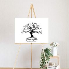 an easel with a tree on it in front of a white wall and floor