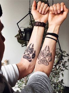 two people with matching tattoos on their arms