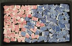 a tray filled with lots of postage stamps