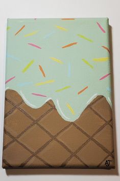 an ice cream cone with sprinkles is painted on a green canvas,