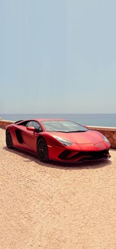 a red sports car parked on the beach